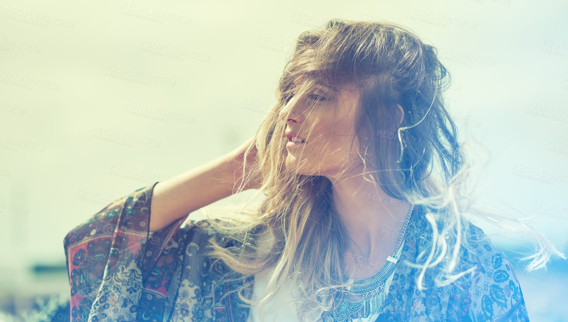 Buy stock photo Shot of a fashionable young woman posing outside on a sunny day