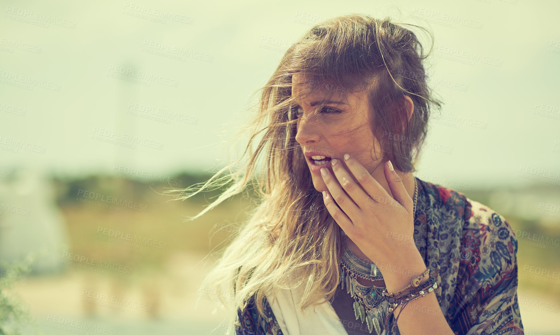 Buy stock photo Shot of a fashionable young woman posing outside on a sunny day