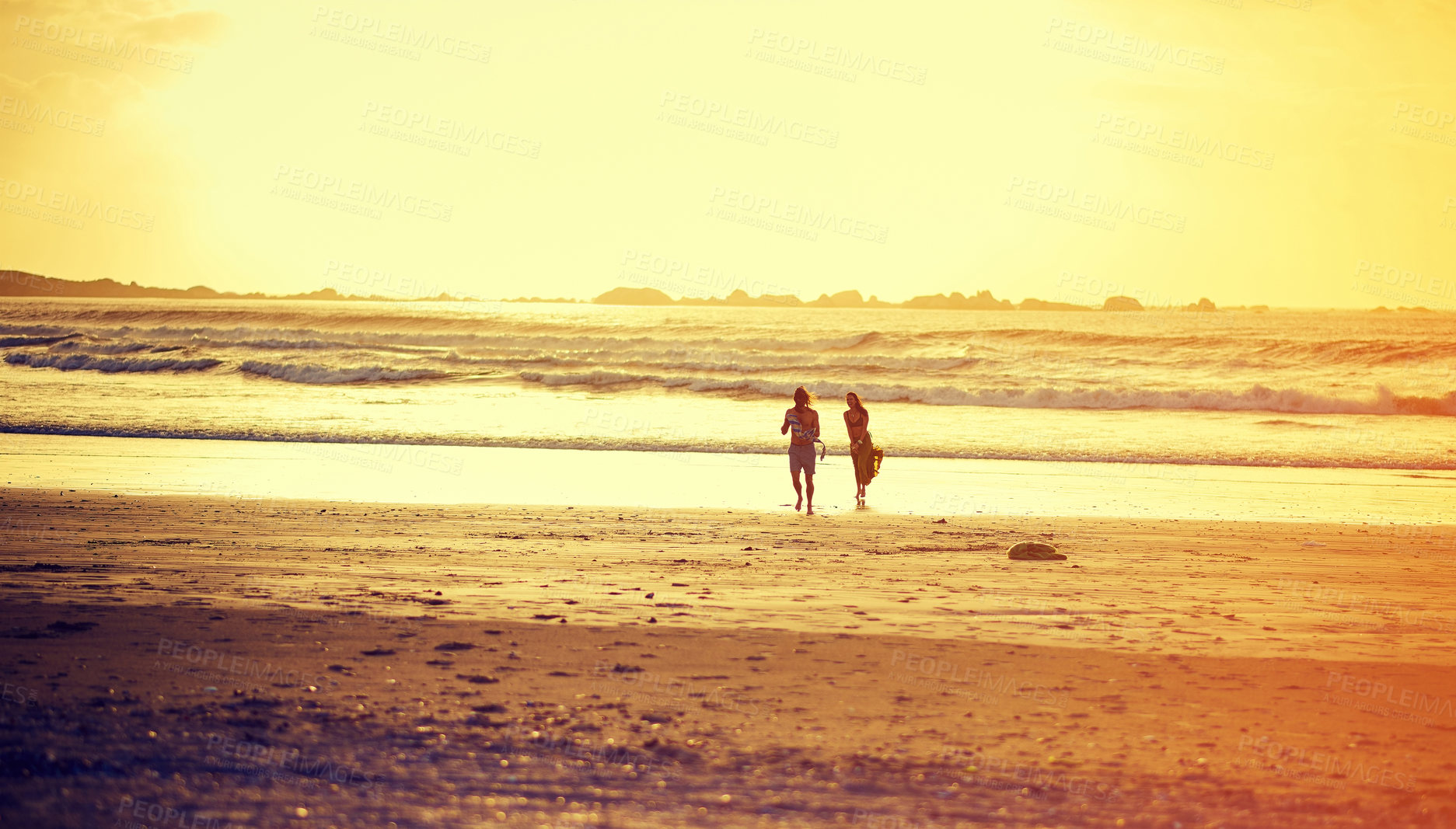 Buy stock photo Shot of an affectionate young couple on the beach