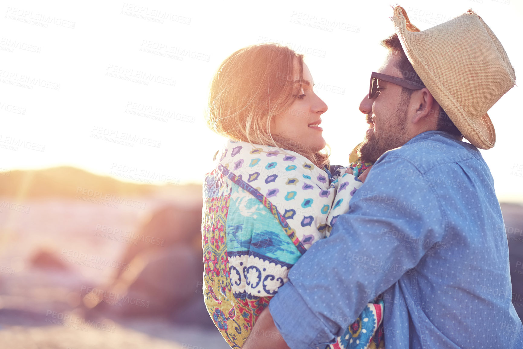 Buy stock photo Shot of an affectionate young couple at the beach