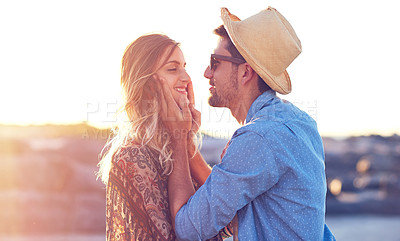 Buy stock photo Shot of an affectionate young couple at the beach