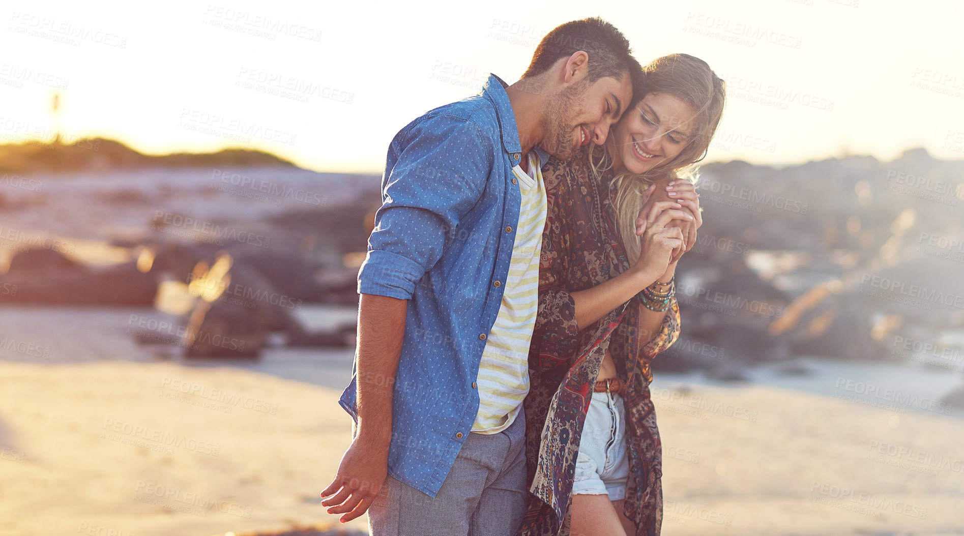 Buy stock photo Shot of a happy young couple going for a walk along the beach