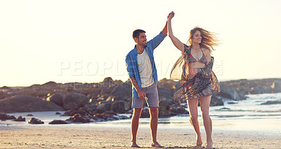 Buy stock photo Shot of an happy young couple dancing at the beach