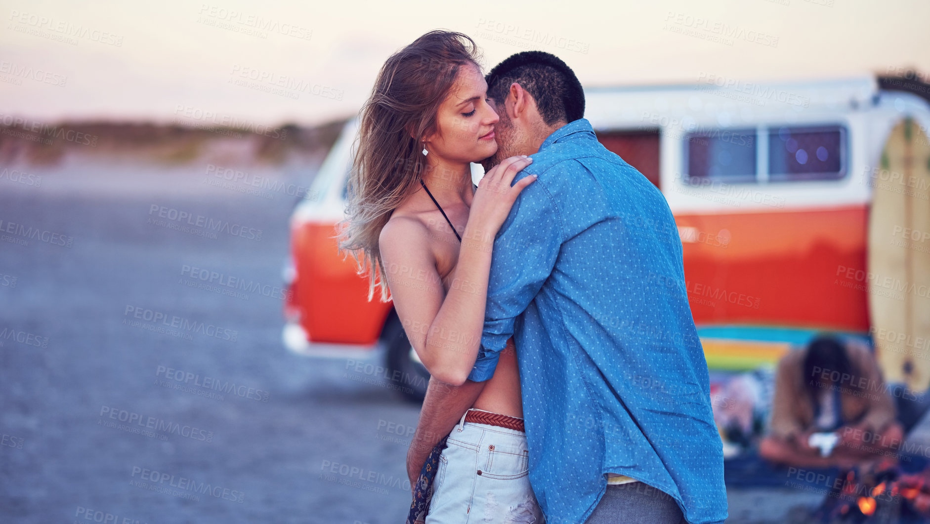 Buy stock photo Shot of an affectionate young couple at the beach