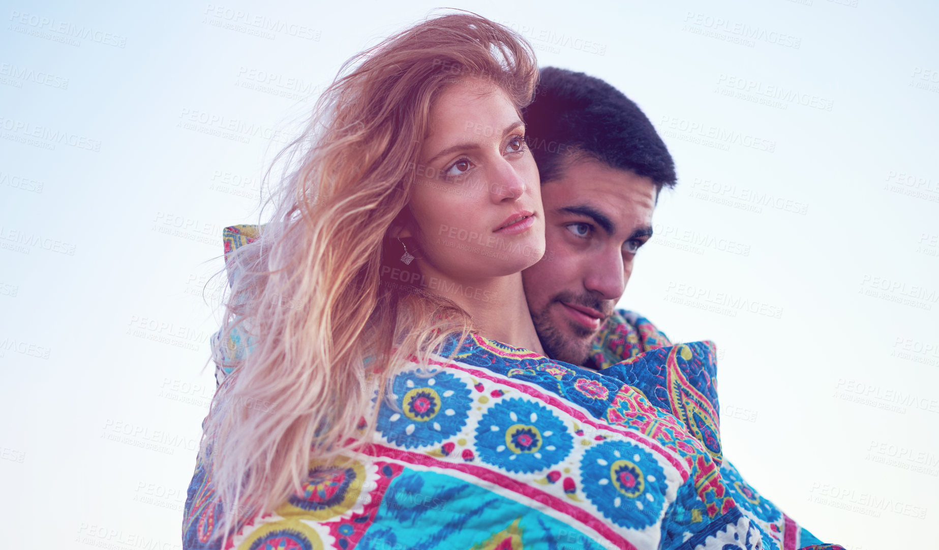 Buy stock photo Shot of an affectionate young couple at the beach