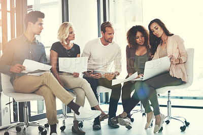 Buy stock photo Shot of a team of designers brainstorming together in an office