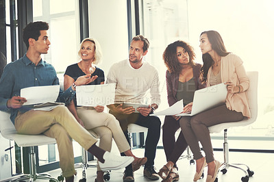 Buy stock photo Shot of a team of designers brainstorming together in an office