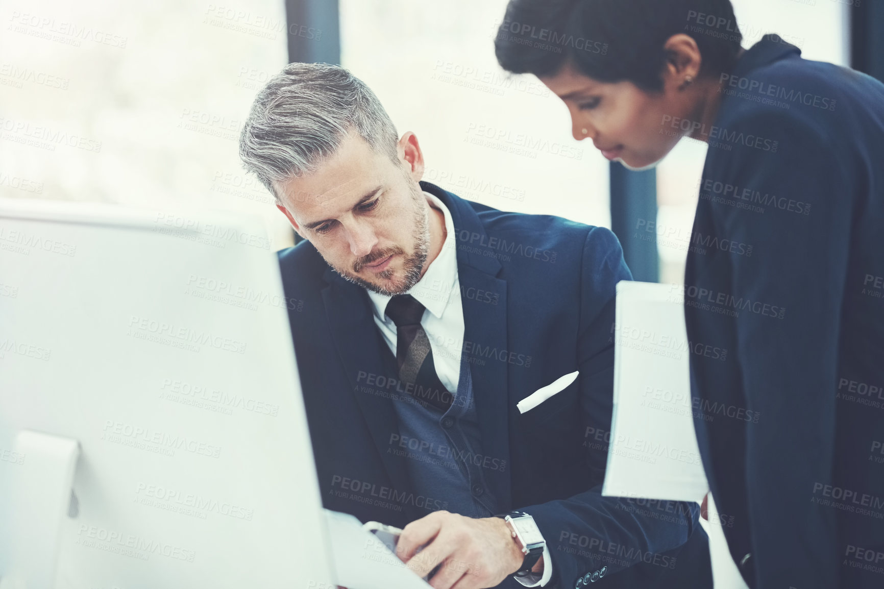 Buy stock photo Shot of a businesswoman and businessman collaborating on a project at work