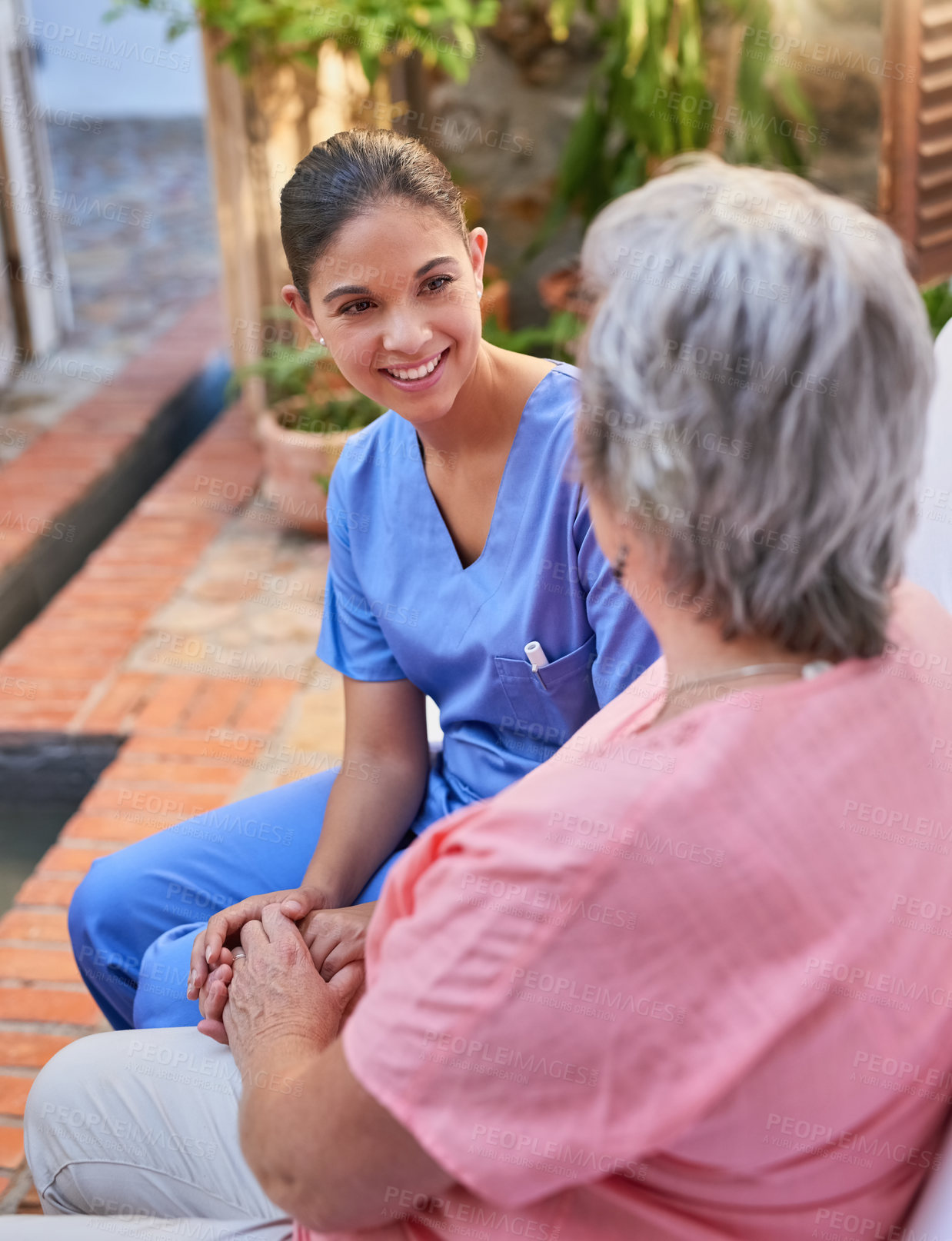 Buy stock photo Cropped shot of a caregiver chatting to a senior patient outside