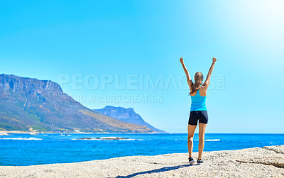 Buy stock photo Fitness, success and woman on beach for winning, achievement or outdoor training exercise. Ocean, celebration and champion runner with arms up, blue sky and morning workout goals in nature from back.