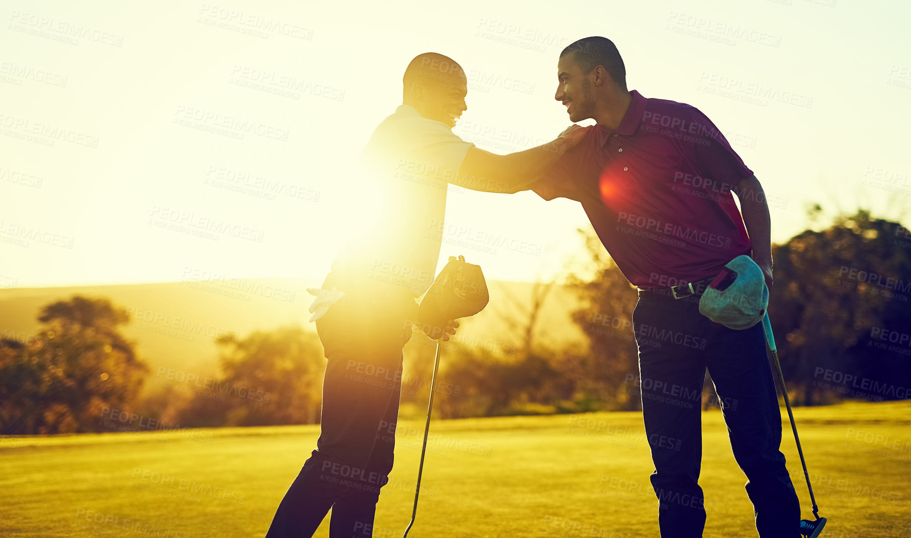 Buy stock photo Shot of two friends playing a round of golf out on a golf course