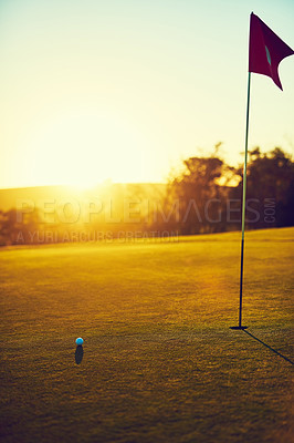 Buy stock photo Shot of a golf ball and flag on an empty course