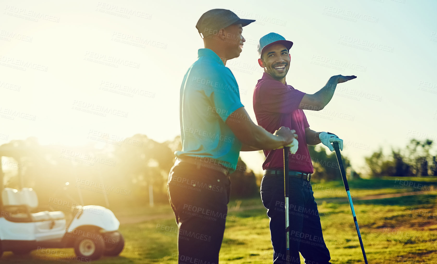 Buy stock photo Shot of two friends playing a round of golf out on a golf course