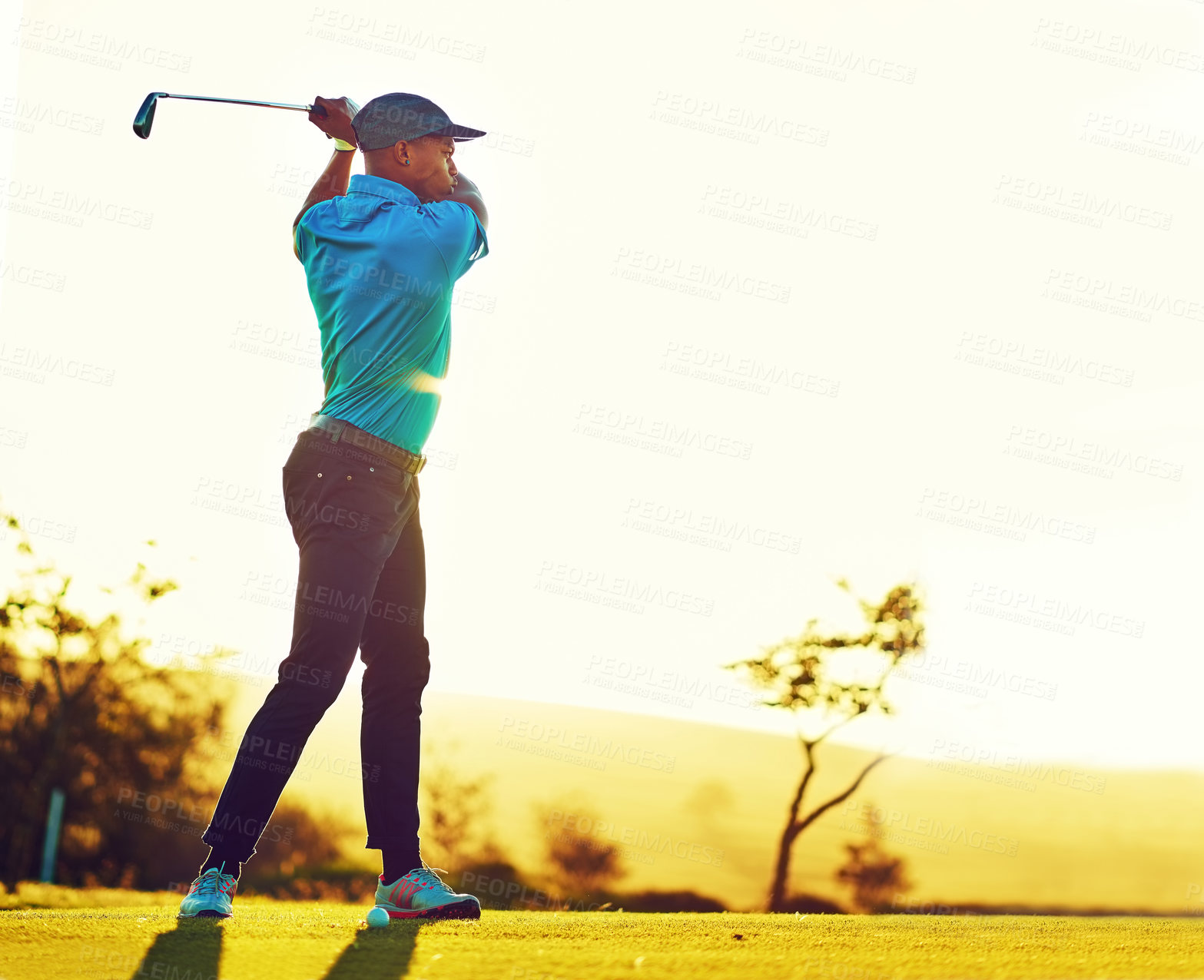 Buy stock photo Shot of a young man playing golf