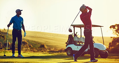 Buy stock photo Shot of two friends playing a round of golf out on a golf course  the day on a golf course