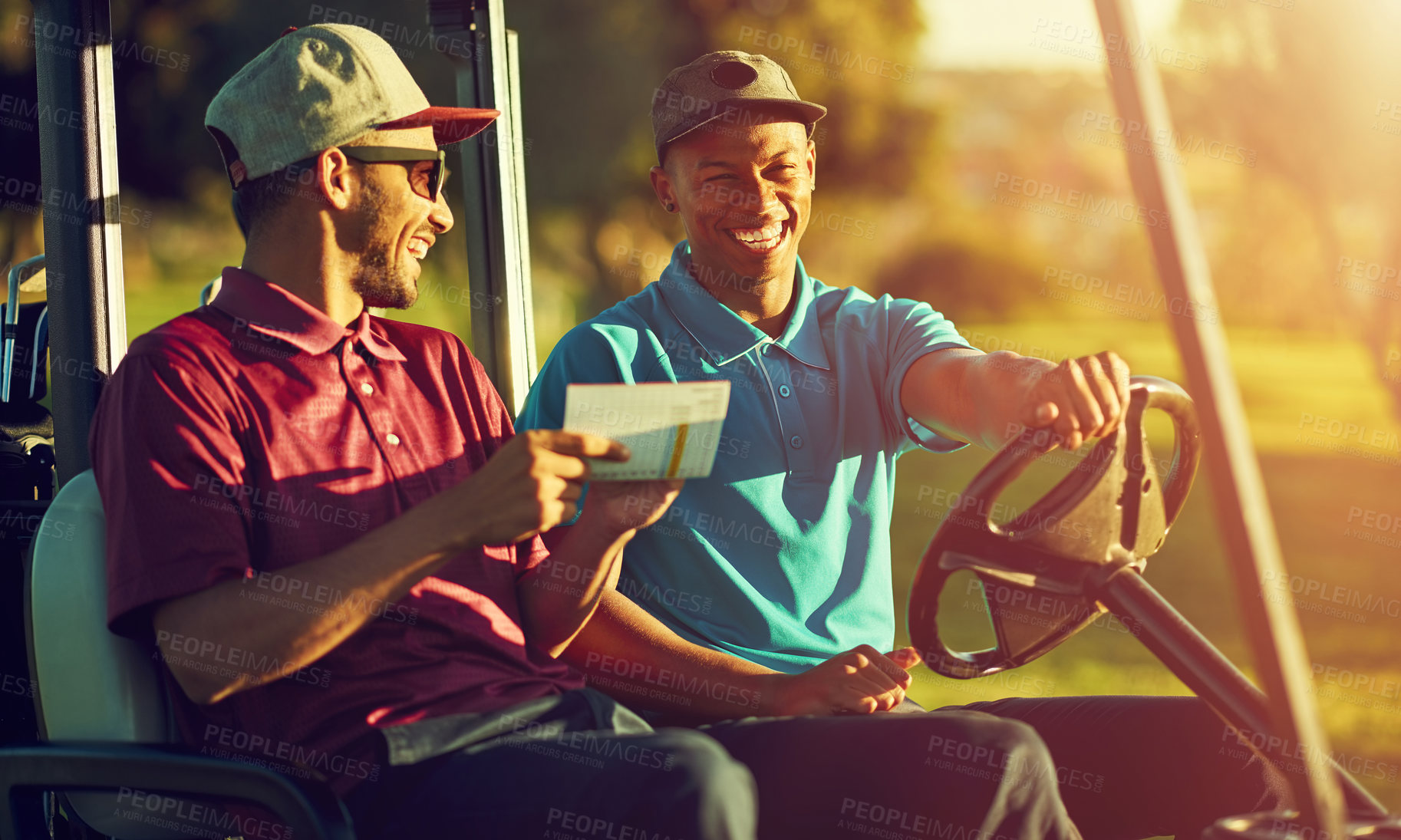 Buy stock photo Shot of two golfers riding in a cart on a golf course