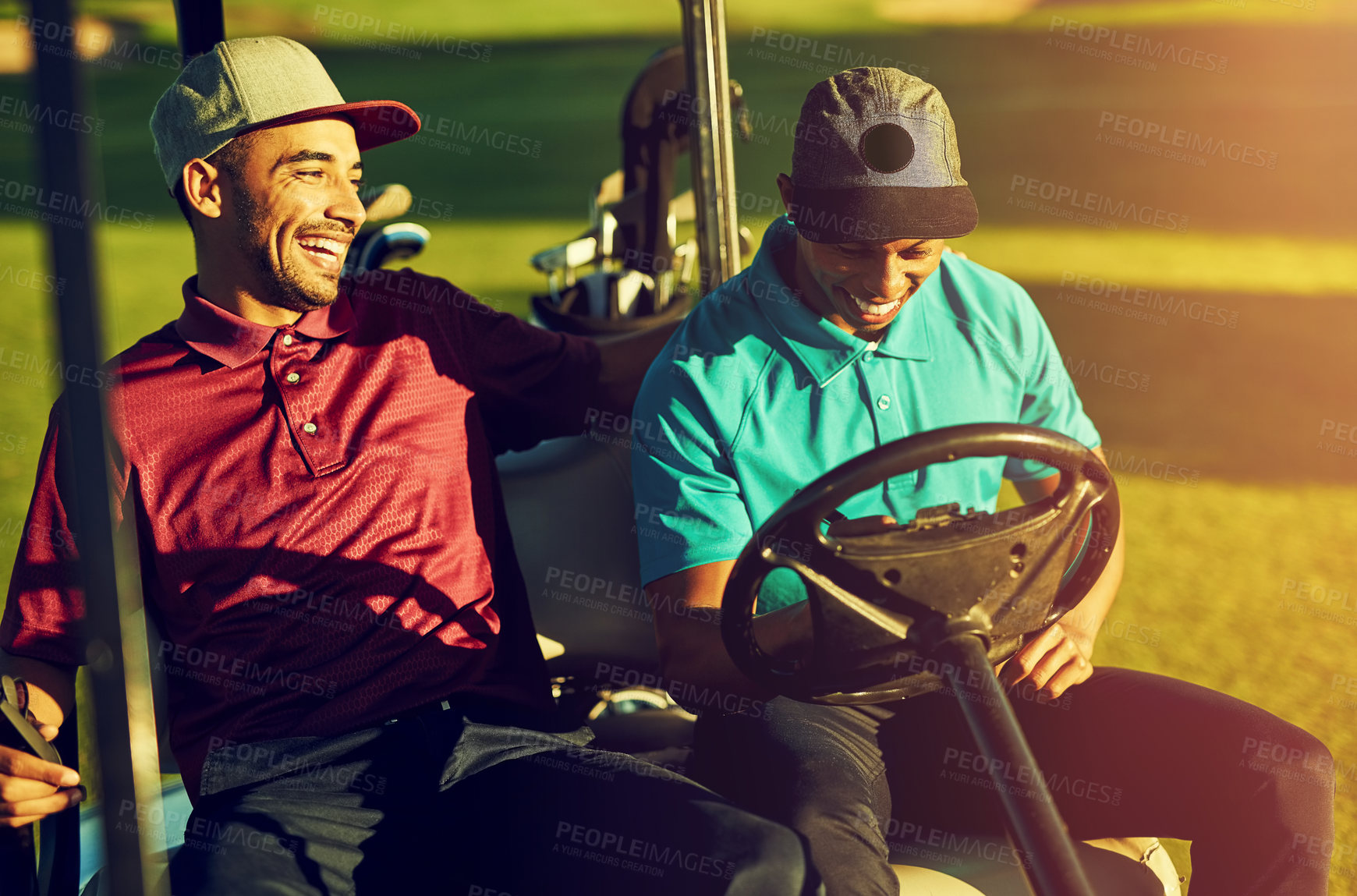 Buy stock photo Shot of two golfers riding in a cart on a golf course