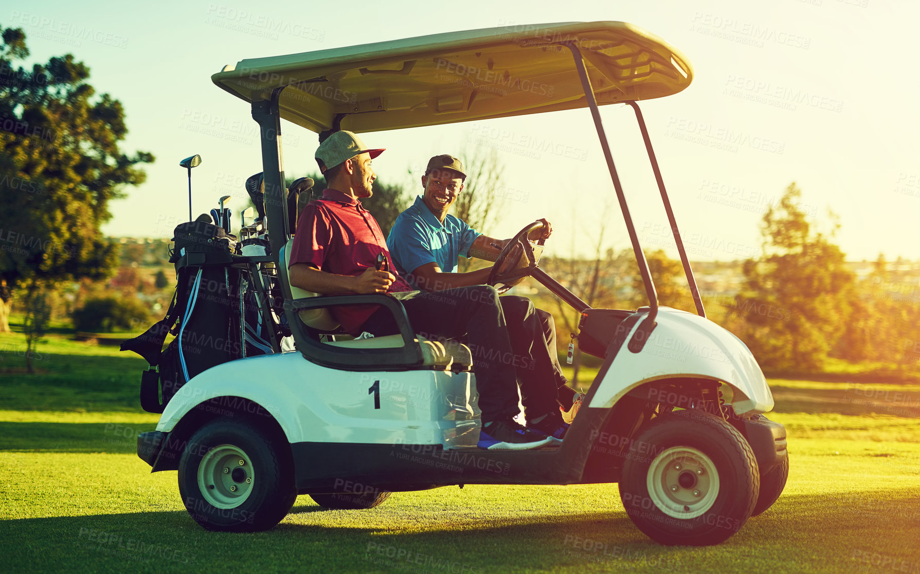 Buy stock photo Shot of two men sitting in a cart on a golf course