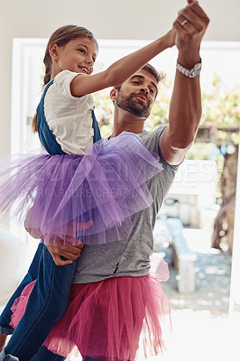 Buy stock photo Father with daughter dancing in tutu, playful and fun at home with bonding with love and care Family, man and girl dance in living room, carefree and spending time together with relationship and joy