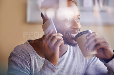 Buy stock photo Cropped shot of a handsome young man using his phone while sitting in a cafe