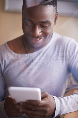 Buy stock photo Shot of a man using his digital tablet