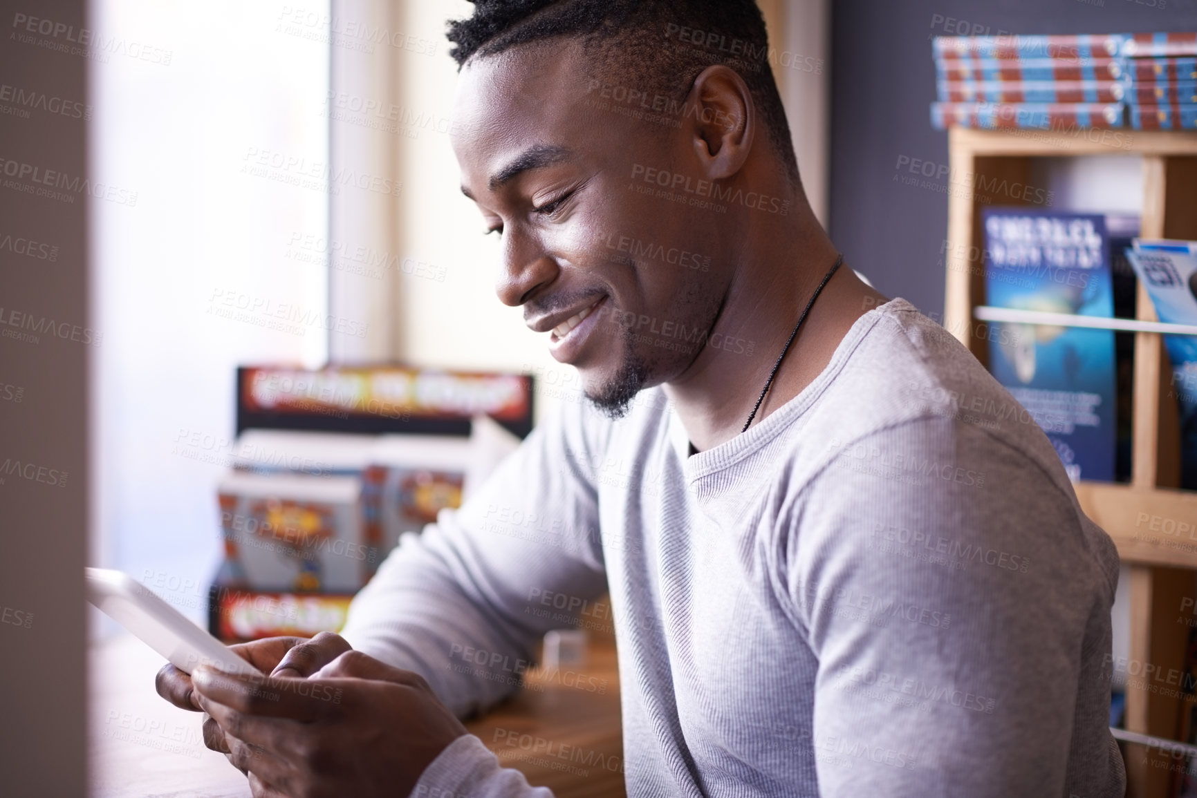Buy stock photo Library, student and black man with tablet, study and digital for research, reading and web for project. Connection, university and guy in shop for books, internet and knowledge to learn in Atlanta