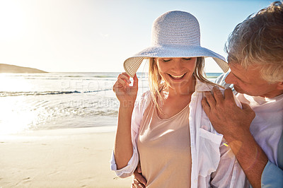 Buy stock photo Senior, happy couple and beach with sunset for love, embrace or bonding together in nature. Man, woman or lovers with smile in joy for outdoor sunshine, summer or holiday by water, sea or ocean coast