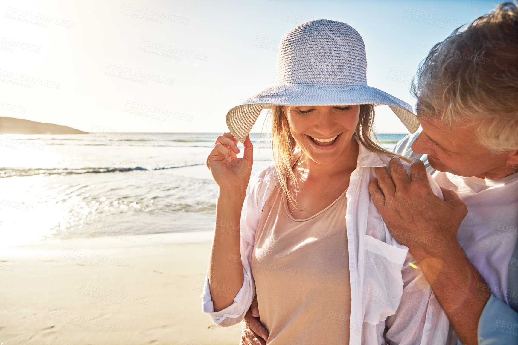 Buy stock photo Senior, happy couple and beach with sunset for love, embrace or bonding together in nature. Man, woman or lovers with smile in joy for outdoor sunshine, summer or holiday by water, sea or ocean coast