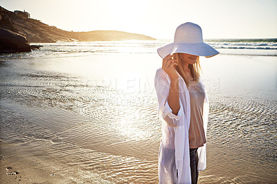 Buy stock photo Shot of a mature woman enjoying a day at the beach