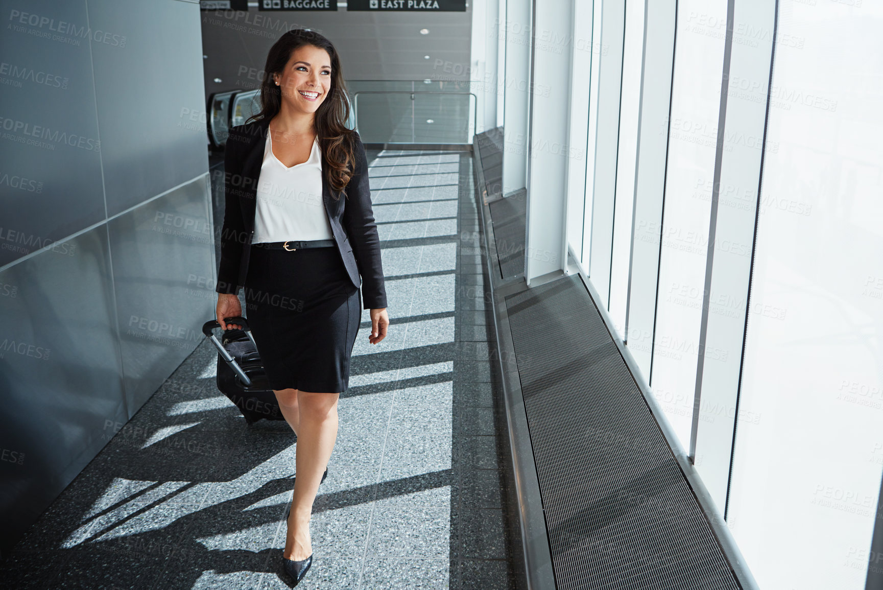 Buy stock photo Flight, thinking or happy woman on business trip walking with suitcase, baggage or luggage. Smile, entrepreneur or corporate worker by window in lobby for travel journey in an international airport