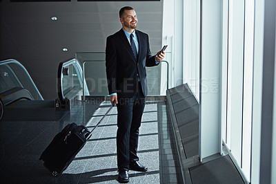 Buy stock photo Happy, thinking or business man in airport with phone, luggage or suitcase waiting to travel. Smile, male entrepreneur or corporate worker texting on social media mobile app on international flight