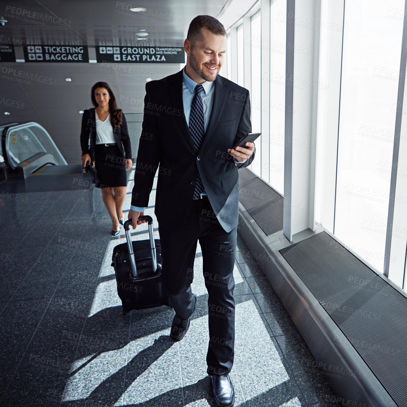 Buy stock photo Business man, smartphone and suitcase in airport hallway with smile, thinking or idea for international travel. Entrepreneur, luggage and phone with flight schedule for global immigration in London