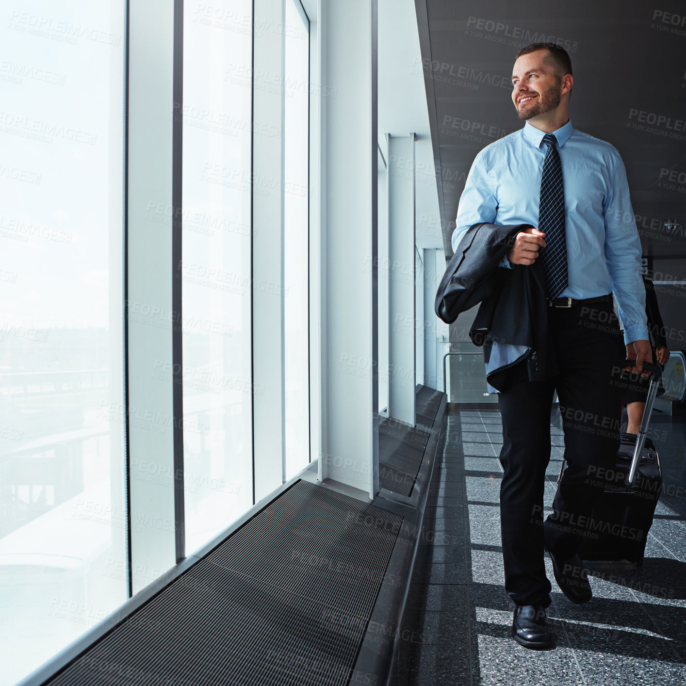 Buy stock photo Walking, thinking or happy businessman in airport for a company trip with suitcase or luggage for commute. Smile, window or corporate workers in lobby for travel or journey on international flight 