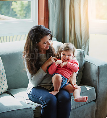 Buy stock photo Mother, daughter and playing or happy in home with relax, bonding and love with embrace or fun together. Family, woman and child or kid with smile for trust, care and security in living room of house