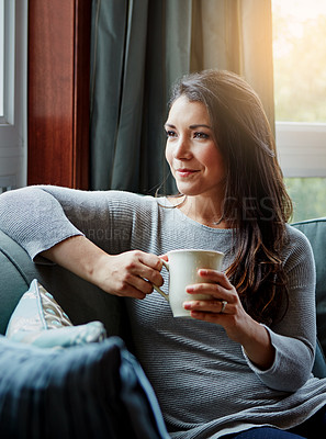 Buy stock photo Shot of an attractive young woman relaxing at home