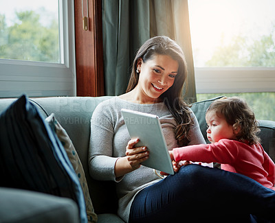 Buy stock photo Mother, tablet and baby playing on sofa in living room for entertainment, bonding or time together at home. Happy mom with cute little daughter, child or kid relaxing on the couch with touchscreen