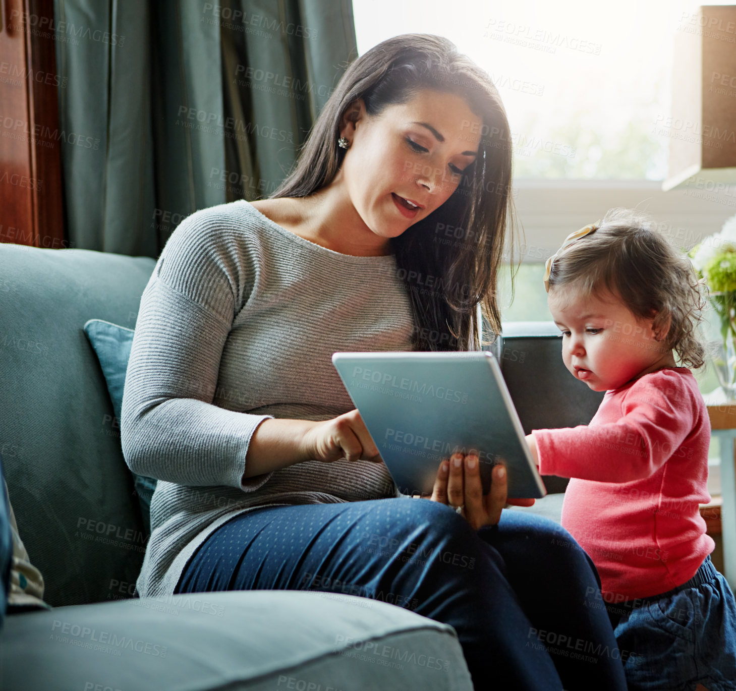 Buy stock photo Education, mother and child with tablet in living room together for internet connection and development in home. Woman, kid or daughter with tech on couch for online learning and studying with love