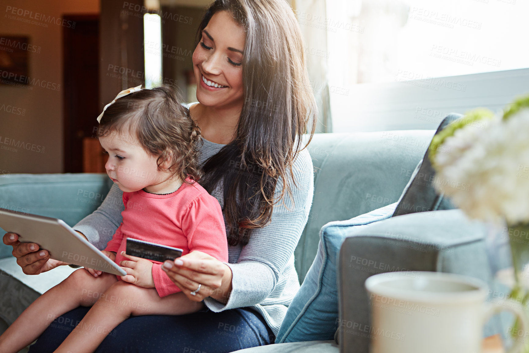 Buy stock photo Credit card, sofa and mother with baby on tablet for online shopping, internet banking and store website. Family, home and mom with young girl on digital tech for purchase, payment and ecommerce