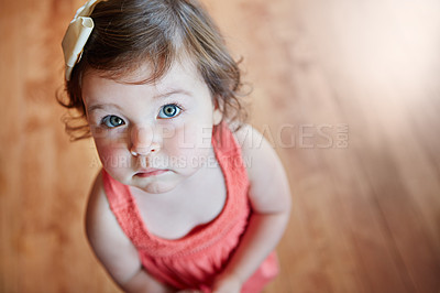 Buy stock photo Cute, adorable and little girl standing while looking up with sweet face on wooden floor at home. Portrait of small girl child, toddler or kid in pink dress, childhood or innocent youth at the house