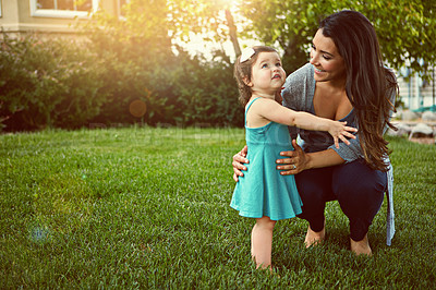 Buy stock photo Shot of a mother bonding with her adorable little daughter outside