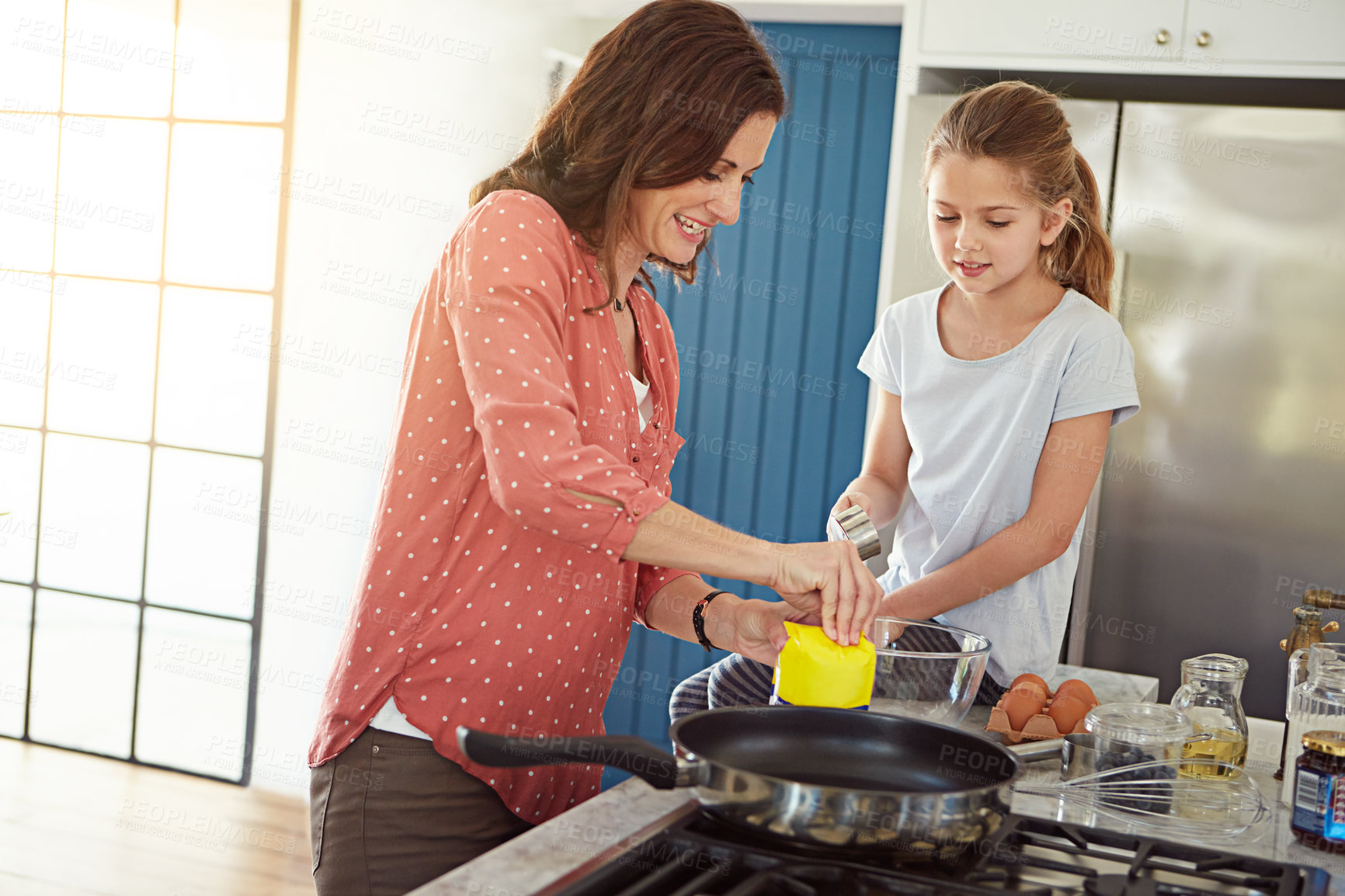 Buy stock photo Cropped shot of a mother baking with her daughter in the kitchen