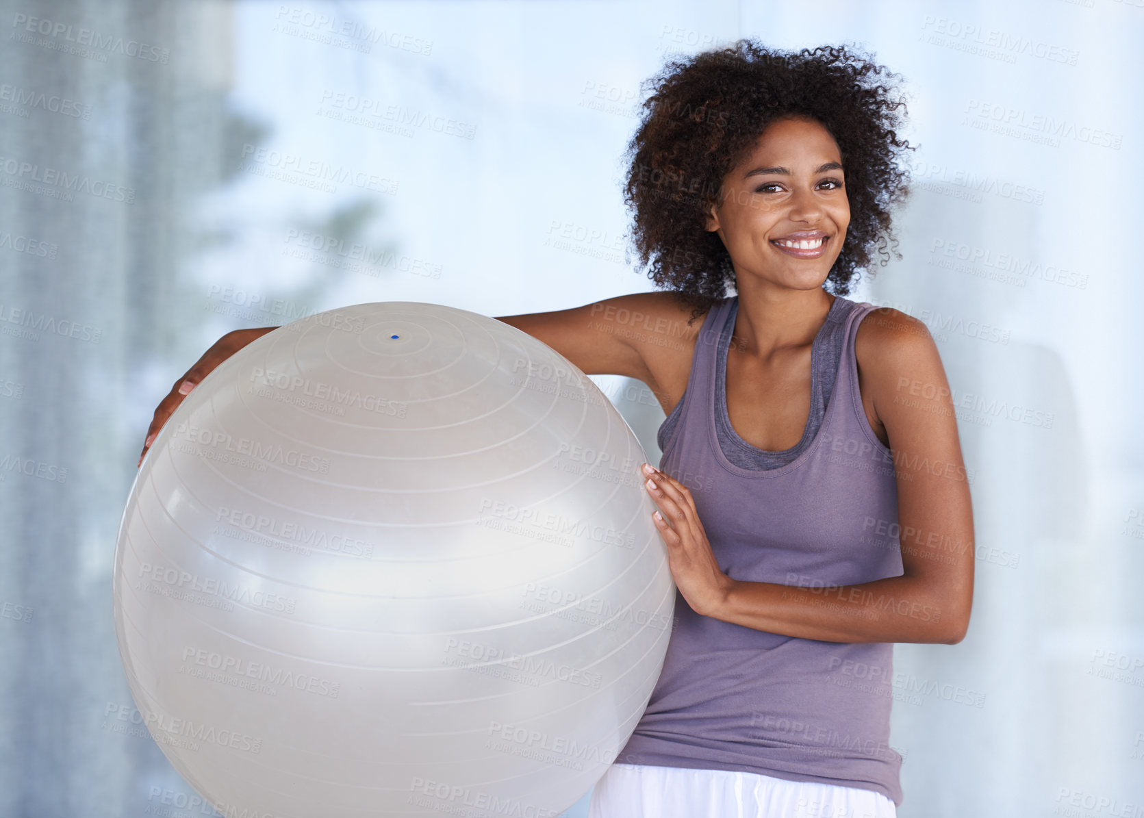Buy stock photo Cropped portrait of an attractive young woman standing with an exercise ball