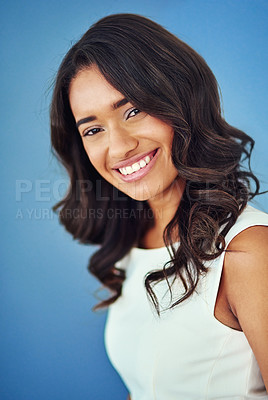 Buy stock photo Confident, portrait and smile of woman in studio, ambition and happy for launch with business loan. Blue background, professional and entrepreneur for self publishing agency, creative and person