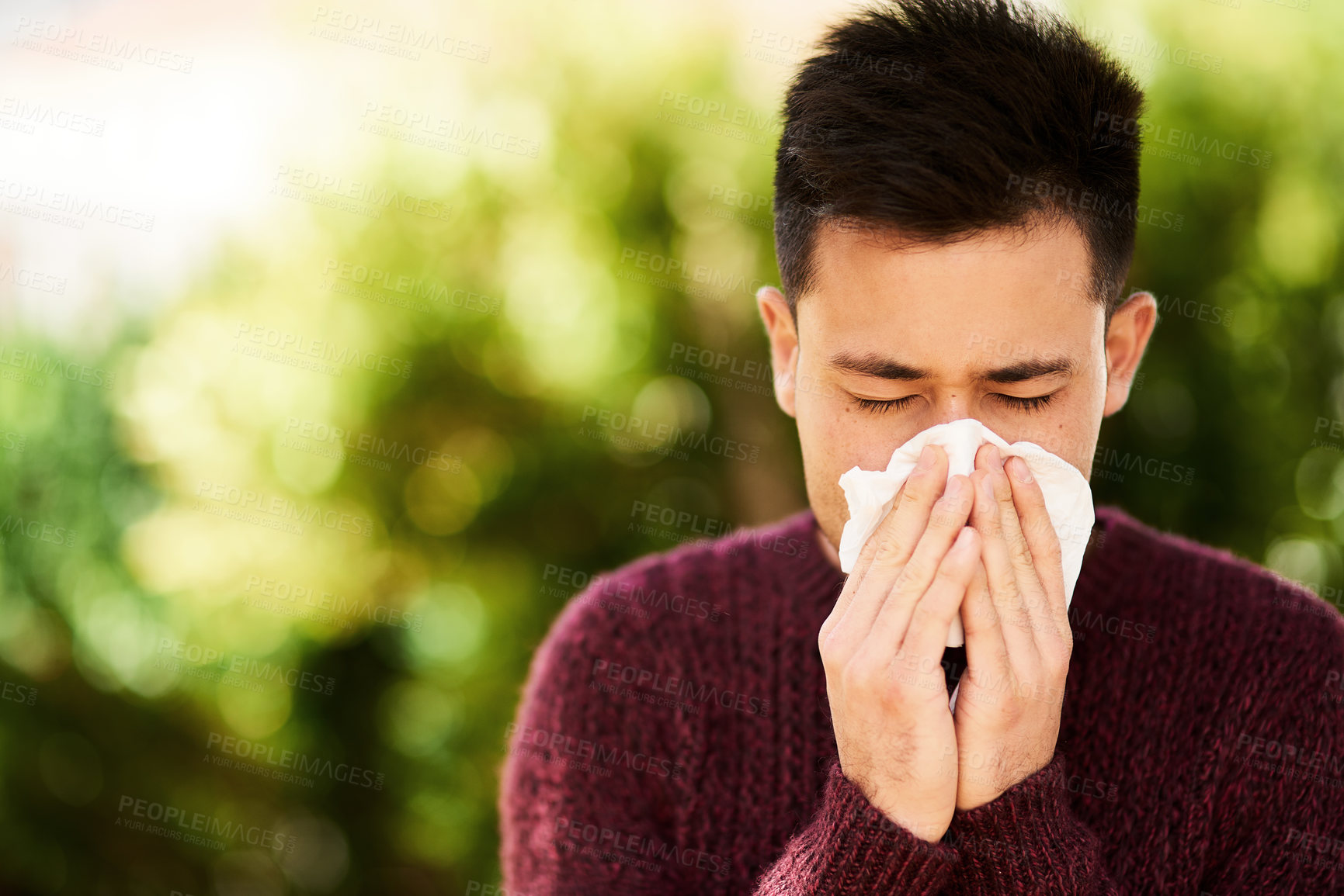 Buy stock photo Man, outdoor and virus with tissue for allergies or pollen, risk of covid or bacteria particles. Male person, eyes closed and blowing nose or sick in nature with care, hands for wellness or health