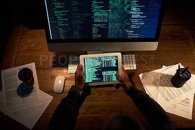 Buy stock photo High angle shot of an unrecognizable man coding on his tablet in the office