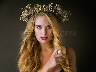 Buy stock photo Portrait, makeup and woman with gold apple isolated on black studio background. Face, food and girl eating forbidden fruit for magic, temptation or sin of model in flower wreath with beauty cosmetics