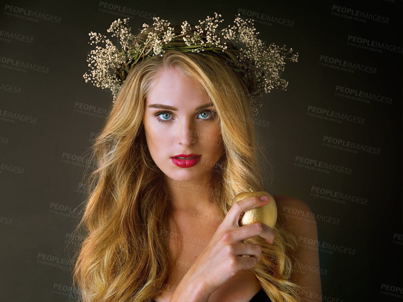 Buy stock photo Portrait, makeup and woman with gold apple isolated on black studio background. Face, food and girl eating forbidden fruit for magic, temptation or sin of model in flower wreath with beauty cosmetics