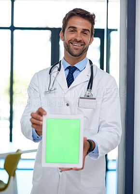 Buy stock photo Portrait of a young doctor holding a digital tablet with a chroma key screen