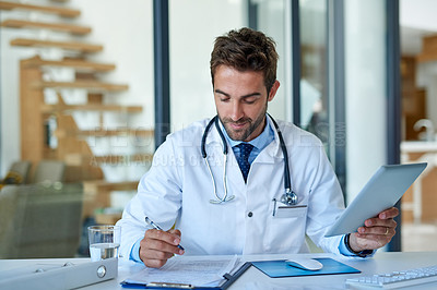 Buy stock photo Cropped shot of a young doctor working in his office
