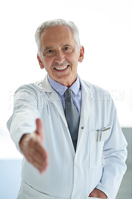 Buy stock photo Portrait of a mature doctor extending a handshake